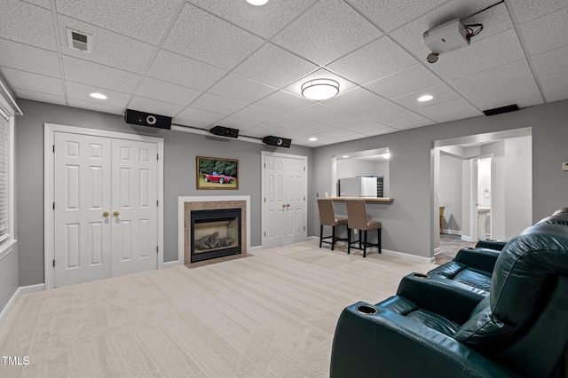 13121 Sargas St, Raleigh, NC 27614 - carpeted living room featuring a drop ceiling, baseboards, a high end fireplace, and recessed lighting