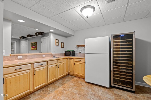 13121 Sargas St, Raleigh, NC 27614 - kitchen with freestanding refrigerator, a paneled ceiling, wine cooler, black microwave, and a sink