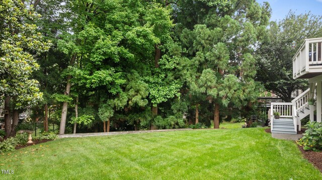 13121 Sargas St, Raleigh, NC 27614 - view of grassy yard featuring stairs and a wooden deck