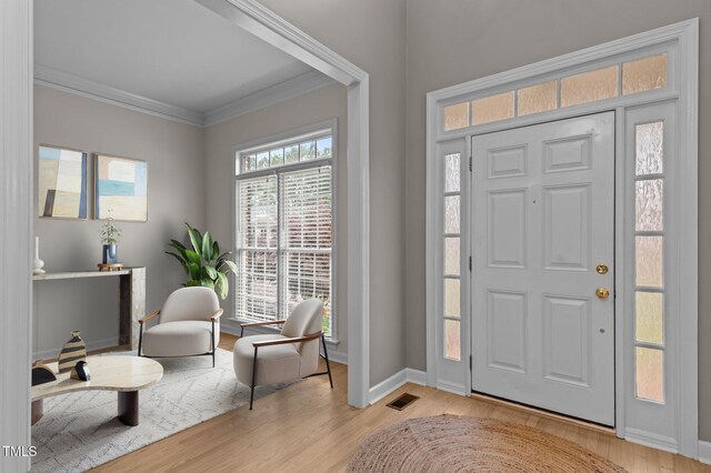 13121 Sargas St, Raleigh, NC 27614 - foyer entrance featuring crown molding, wood finished floors, and baseboards