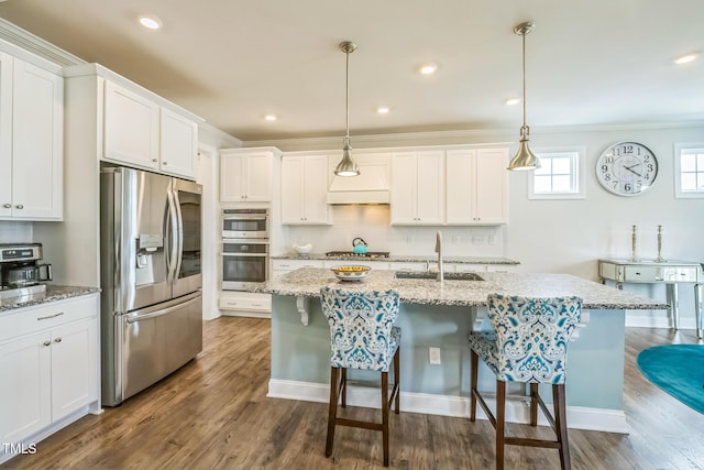 40 Two Creeks Loop, Chapel Hill, NC 27517 - kitchen featuring appliances with stainless steel finishes, white cabinetry, a breakfast bar, dark wood-style flooring, and an island with sink