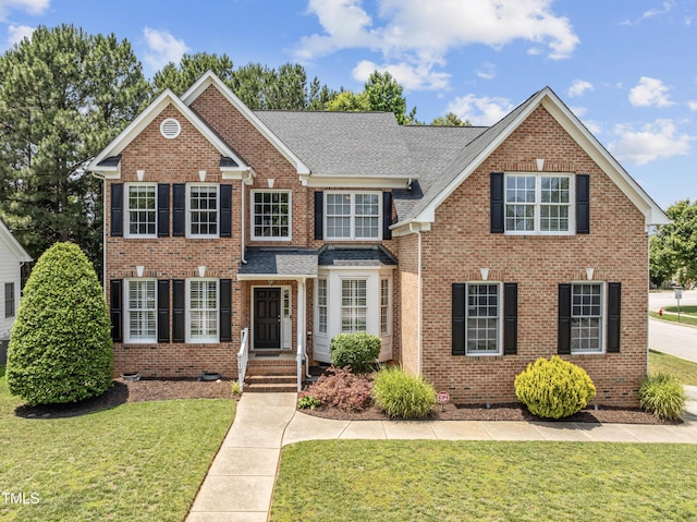 712 Brittley Way, Apex, NC 27502 - view of front of house with crawl space, brick siding, a front yard, and a shingled roof