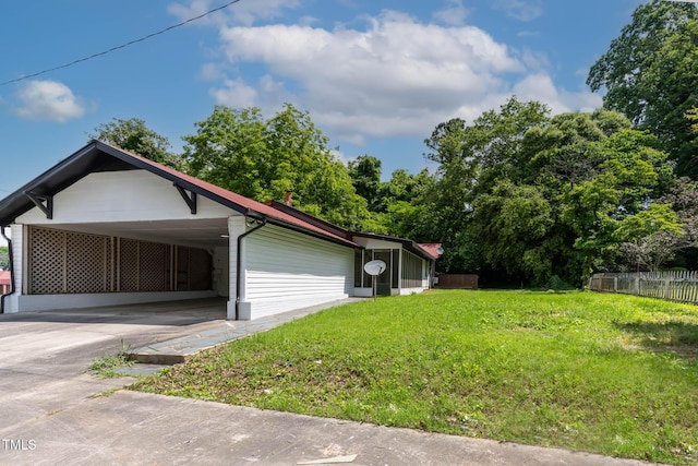 519 W Raleigh St, Siler City, NC 27344 - view of side of property with concrete driveway and an attached carport