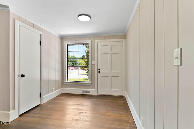 519 W Raleigh St, Siler City, NC 27344 - entrance foyer with crown molding, dark wood-style floors, baseboards, and a decorative wall
