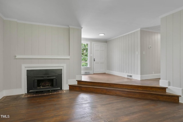 519 W Raleigh St, Siler City, NC 27344 - unfurnished living room with wood finished floors, crown molding, a large fireplace, and baseboards
