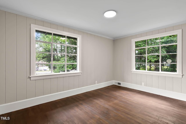 519 W Raleigh St, Siler City, NC 27344 - unfurnished room with baseboards, healthy amount of natural light, dark wood-style flooring, and ornamental molding