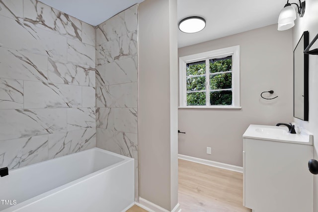 519 W Raleigh St, Siler City, NC 27344 - full bath featuring vanity, wood finished floors, baseboards, and  shower combination