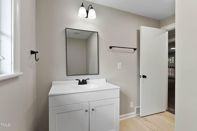 519 W Raleigh St, Siler City, NC 27344 - bathroom with vanity, wood finished floors, and baseboards
