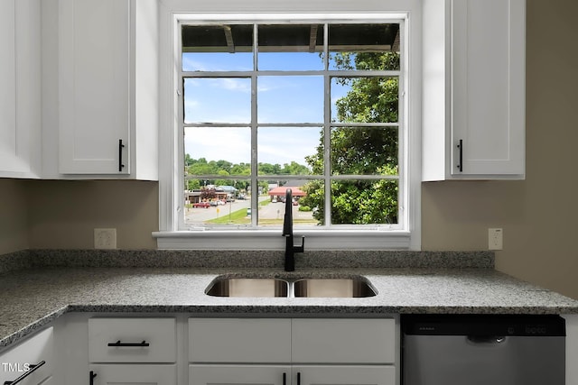 519 W Raleigh St, Siler City, NC 27344 - kitchen with dishwasher, a sink, healthy amount of natural light, and white cabinetry