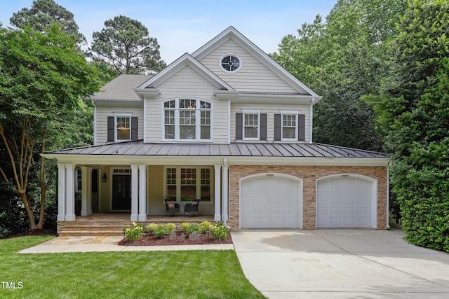 118 Killingsworth Dr, Cary, NC 27518 - view of front of house with a standing seam roof, driveway, covered porch, and a front yard