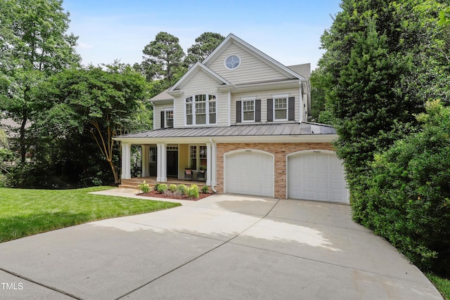 118 Killingsworth Dr, Cary, NC 27518 - view of front of home featuring covered porch, driveway, a standing seam roof, a front yard, and an attached garage