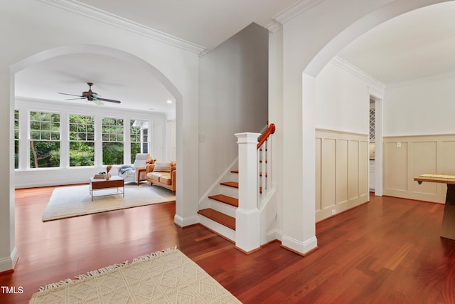 118 Killingsworth Dr, Cary, NC 27518 - stairs with a ceiling fan, wood finished floors, arched walkways, ornamental molding, and wainscoting