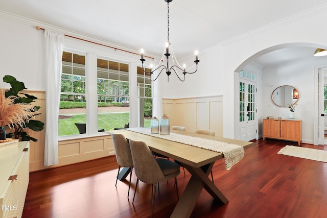 118 Killingsworth Dr, Cary, NC 27518 - dining area with arched walkways, dark wood-type flooring, crown molding, a decorative wall, and a chandelier