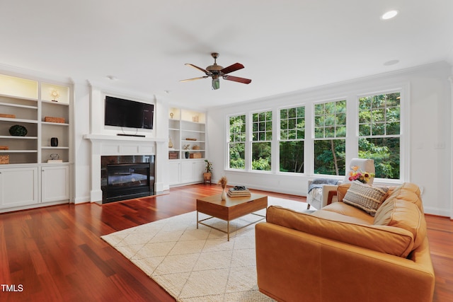 118 Killingsworth Dr, Cary, NC 27518 - living area with plenty of natural light, crown molding, wood finished floors, a fireplace with flush hearth, and ceiling fan