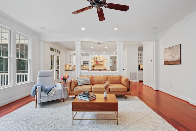 118 Killingsworth Dr, Cary, NC 27518 - living room featuring decorative columns, ornamental molding, light wood finished floors, ceiling fan, and baseboards
