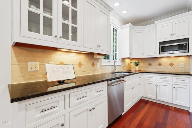 118 Killingsworth Dr, Cary, NC 27518 - kitchen featuring stainless steel appliances, white cabinetry, ornamental molding, and recessed lighting