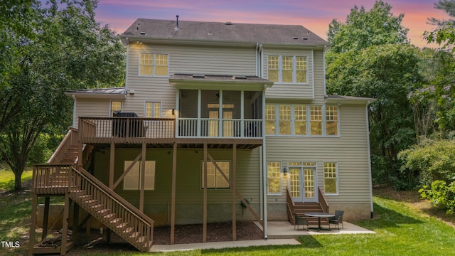118 Killingsworth Dr, Cary, NC 27518 - back of house at dusk with stairway, a patio area, a sunroom, a deck, and a lawn