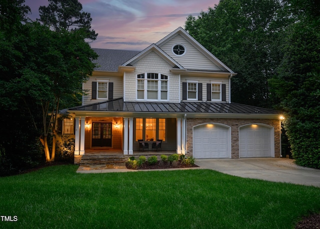 118 Killingsworth Dr, Cary, NC 27518 - view of front facade with a standing seam roof, driveway, covered porch, a front yard, and metal roof