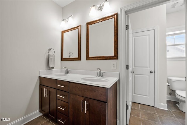 2256 Toad Hollow Trl, Apex, NC 27502 - bathroom featuring toilet, double vanity, tile patterned floors, and baseboards