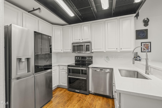 1535 Caraleigh Mills Ct Unit 210, Raleigh, NC 27603 - kitchen with stainless steel appliances, white cabinetry, a sink, and light countertops