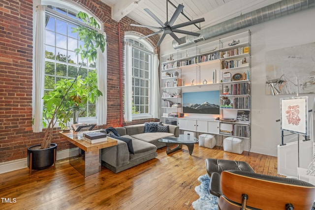 1535 Caraleigh Mills Ct Unit 210, Raleigh, NC 27603 - living room with brick wall, hardwood / wood-style floors, a ceiling fan, beam ceiling, and baseboards