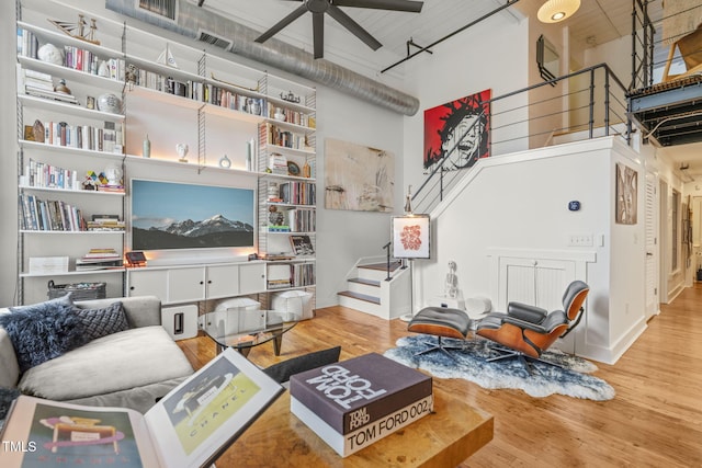 1535 Caraleigh Mills Ct Unit 210, Raleigh, NC 27603 - living room with a towering ceiling, wood finished floors, a ceiling fan, stairs, and baseboards