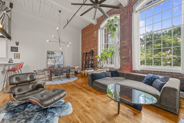 1535 Caraleigh Mills Ct Unit 210, Raleigh, NC 27603 - living room featuring brick wall, high vaulted ceiling, ceiling fan, healthy amount of natural light, and wood-type flooring