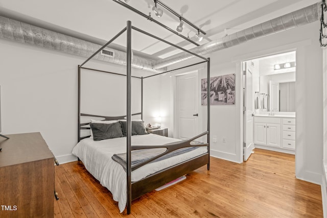 1535 Caraleigh Mills Ct Unit 210, Raleigh, NC 27603 - bedroom with light wood finished floors, a sink, and baseboards