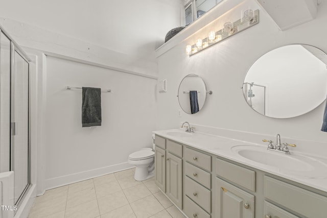 1535 Caraleigh Mills Ct Unit 210, Raleigh, NC 27603 - bathroom featuring double vanity, toilet, a shower with shower door, tile patterned flooring, and baseboards