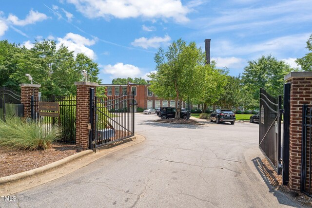 1535 Caraleigh Mills Ct Unit 210, Raleigh, NC 27603 - view of asphalt road featuring a gate and curbs