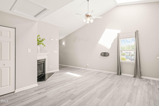 1375 Quail Cir, Creedmoor, NC 27522 - unfurnished living room with wood finished floors, vaulted ceiling, a fireplace with flush hearth, a ceiling fan, and baseboards