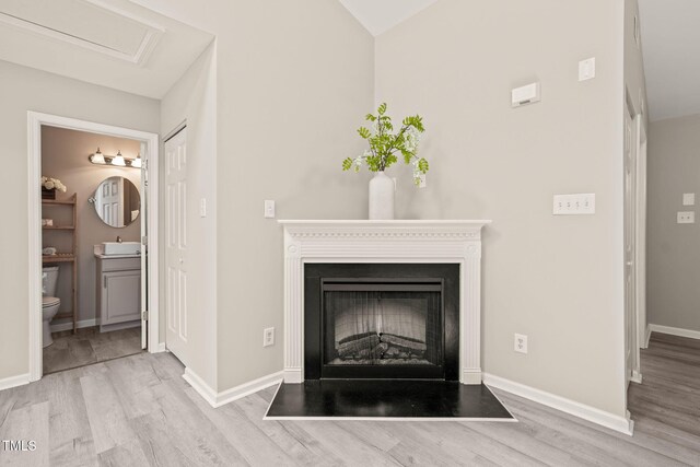 1375 Quail Cir, Creedmoor, NC 27522 - detailed view of wood finished floors, a fireplace with flush hearth, baseboards, and a sink
