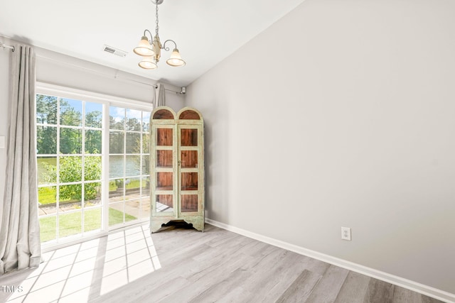 1375 Quail Cir, Creedmoor, NC 27522 - unfurnished room with a chandelier, light wood-style floors, and baseboards