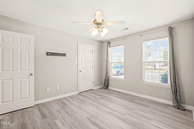 1375 Quail Cir, Creedmoor, NC 27522 - empty room with light wood finished floors, a ceiling fan, and baseboards