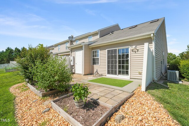1375 Quail Cir, Creedmoor, NC 27522 - back of property featuring central air condition unit, a garden, and a patio