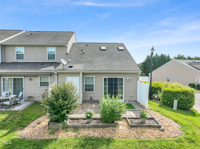 1375 Quail Cir, Creedmoor, NC 27522 - rear view of house with a vegetable garden and a patio area
