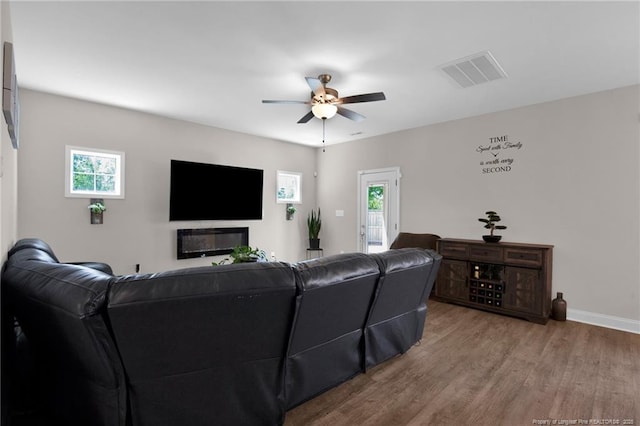 405 Shelton Beard Rd, Stedman, NC 28391 - living area featuring wood finished floors, a ceiling fan, healthy amount of natural light, and baseboards