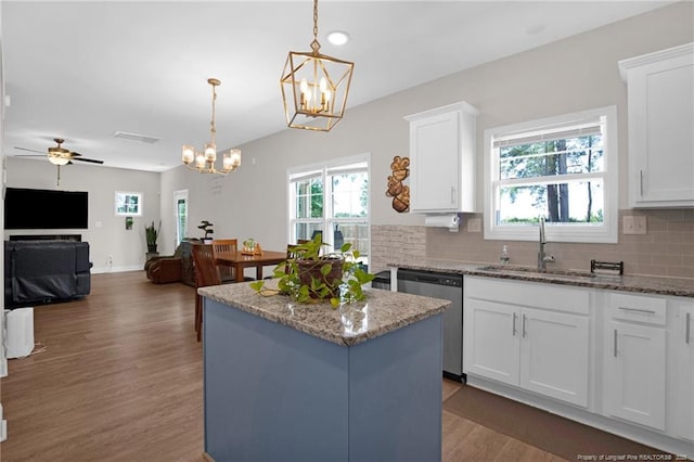 405 Shelton Beard Rd, Stedman, NC 28391 - kitchen featuring stainless steel dishwasher, a sink, a chandelier, wood finished floors, and decorative backsplash