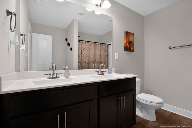 405 Shelton Beard Rd, Stedman, NC 28391 - full bath featuring double vanity, wood finished floors, toilet, baseboards, and curtained shower