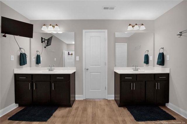 405 Shelton Beard Rd, Stedman, NC 28391 - full bathroom featuring wood finished floors, two vanities, and baseboards