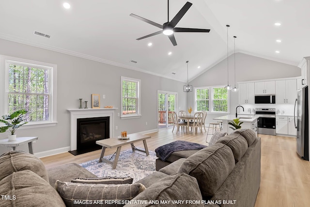 154 Buckaroo Dr, Louisburg, NC 27549 - living room with ceiling fan, light wood-style flooring, a glass covered fireplace, lofted ceiling, and recessed lighting