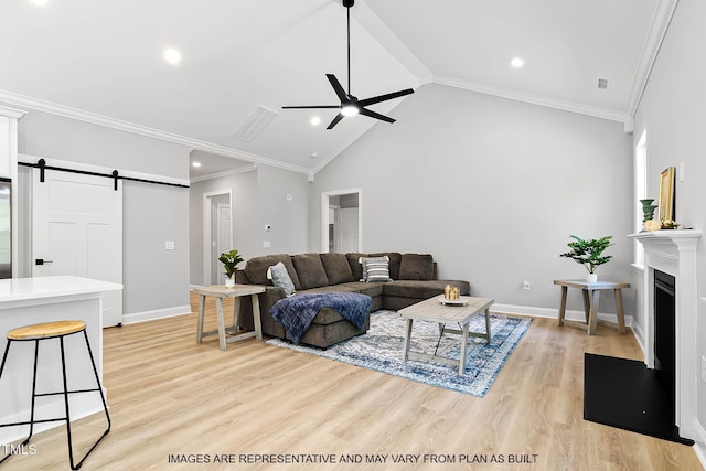 154 Buckaroo Dr, Louisburg, NC 27549 - living area with ceiling fan, crown molding, a barn door, light wood-style floors, and baseboards