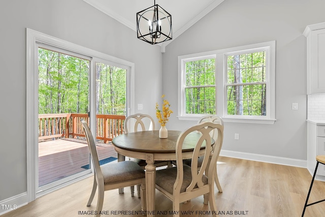 154 Buckaroo Dr, Louisburg, NC 27549 - dining space with vaulted ceiling, a chandelier, light wood-style flooring, baseboards, and ornamental molding