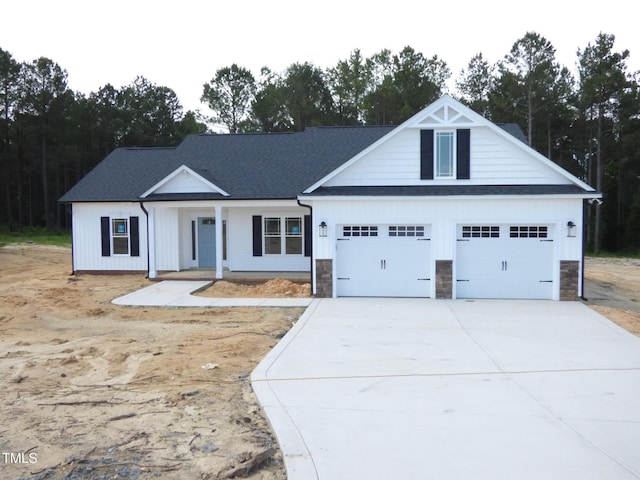 788 Shade Tree Rd, Benson, NC 27504 - view of front of property with driveway, roof with shingles, covered porch, and stone siding