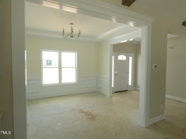788 Shade Tree Rd, Benson, NC 27504 - entryway featuring a chandelier, a wainscoted wall, concrete flooring, and ornamental molding