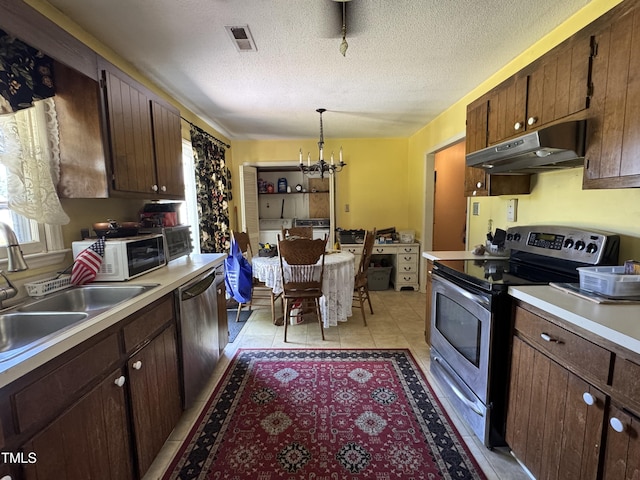 8405 Falcon Crest Cir, Angier, NC 27501 - kitchen with appliances with stainless steel finishes, under cabinet range hood, a chandelier, a sink, and light countertops