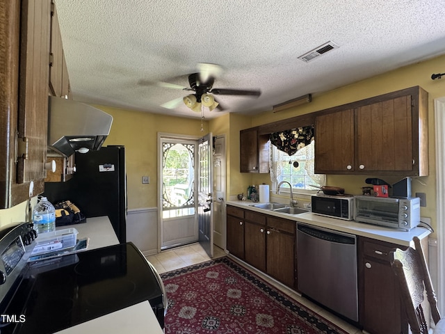 8405 Falcon Crest Cir, Angier, NC 27501 - kitchen with appliances with stainless steel finishes, a sink, light countertops, exhaust hood, and a textured ceiling