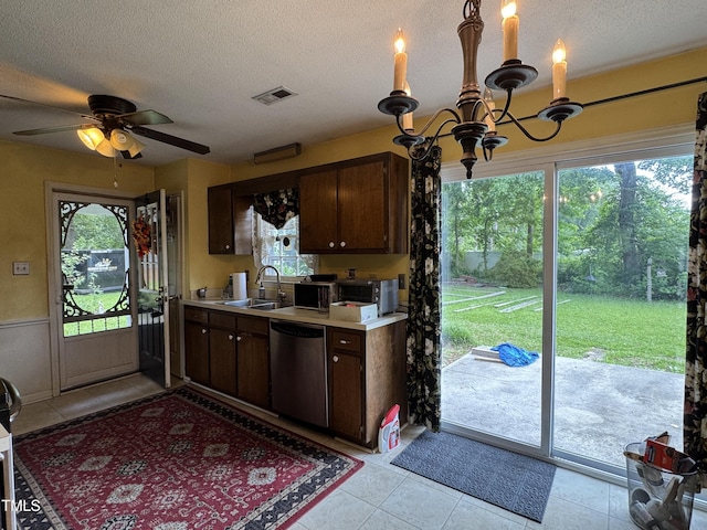 8405 Falcon Crest Cir, Angier, NC 27501 - kitchen with stainless steel dishwasher, healthy amount of natural light, a chandelier, light countertops, and a textured ceiling