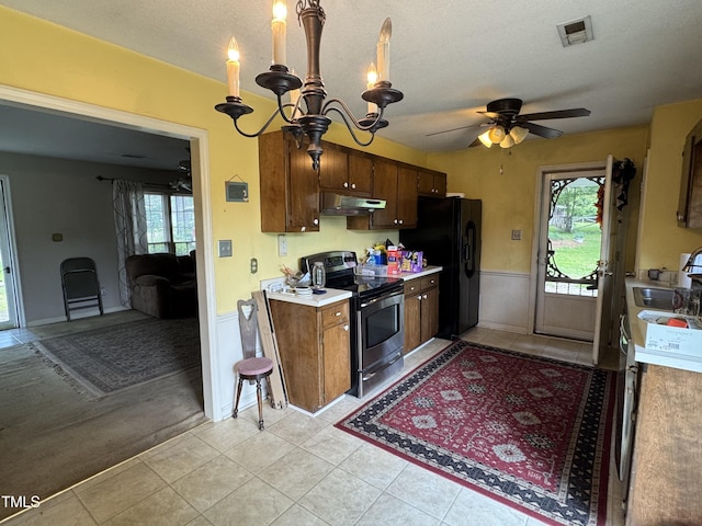 8405 Falcon Crest Cir, Angier, NC 27501 - kitchen featuring stainless steel range with electric stovetop, under cabinet range hood, black fridge with ice dispenser, light countertops, and a chandelier