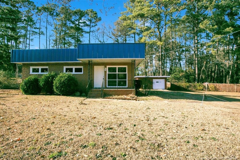1453 Pamalee Dr, Fayetteville, NC 28303 - view of front of home featuring brick siding and a garage